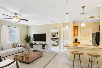 A living room with a bar area and a television.